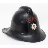 A c1960s Auxiliary Fire Service helmet with applied Kent insignia,