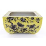 A Chinese yellow oblong planter decorated with black cherry blossom and peonies,