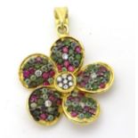 A silver gilt pendant of floral form set with red white and green coloured stones.