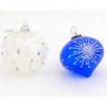 Christmas decorations : two glass baubles one blue the other white.