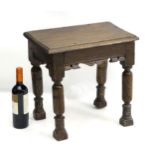 A late 17thC oak stool of peg jointed construction with rectangular moulded top above carved apron,