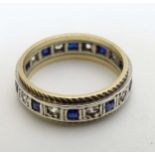 A 9ct gold ring set with blue and white stones.