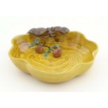 A Chinese wavy edged yellow brush wash dish with bat and fruit decoration,