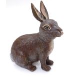 A 21stC cold painted figure of a seated rabbit/hare.