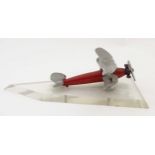 A desktop model Biplane, of metal construction with red and silver painted finish,