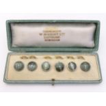 A cased set of 6 gilt metal dress studs / buttons having green guilloche enamel decoration