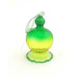Christmas decoration : A green glass decoration formed as a stylised bell .