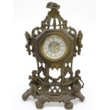 West of Germany : a brass cased mantle clock ( Timepiece ) depicting figures sat below a pillared