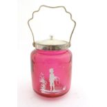 A cranberry glass biscuit barrel with Mary Gregory style decoration and silver plate top and lid.