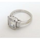 A 9ct white gold ring set with white stone flanked by 2 further stones CONDITION: