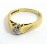 An 18ct gold ring set with central diamond CONDITION: Please Note - we do not make