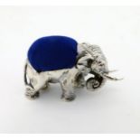 A novelty white metal pin cushion formed as an elephant.