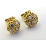 A pair of 18ct gold stud earrings set with white stones.