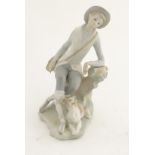 An unglazed Lladro figure of a shepherd boy with a dog, approx. 8" high.