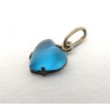 A pendant / charm of heart form set with turquoise coloured heart shaped stone in a white metal