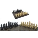 A set of resin copies of the Lewis Chessmen together with a board decorated with celtic patterns.
