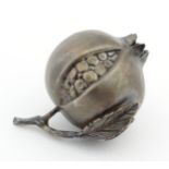 A 21stC white metal model of a pomegranate fruit, 2 3/4" long.