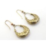 A pair of 9ct gold and yellow metal drop earrings with engraved decoration..
