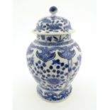 A Chinese blue and white ginger jar with panelled floral and butterfly decoration,