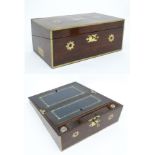 A Victorian Rosewood writing box with brass inlay and corners and having military style handles.