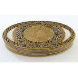 Art Nouveau : An oval gilded bronze and silver plate box having an image of a maiden picking fruit