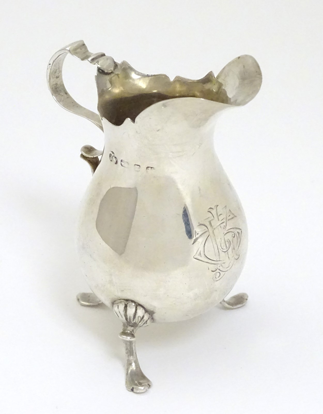 A silver cream jug,