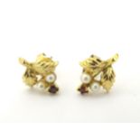 A pair of 9ct gold stud earrings set with pearls and red stones CONDITION: Please