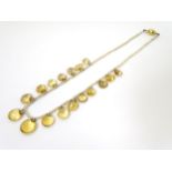 A small pearl bead choker necklace set with various graduated facet cut citrines.