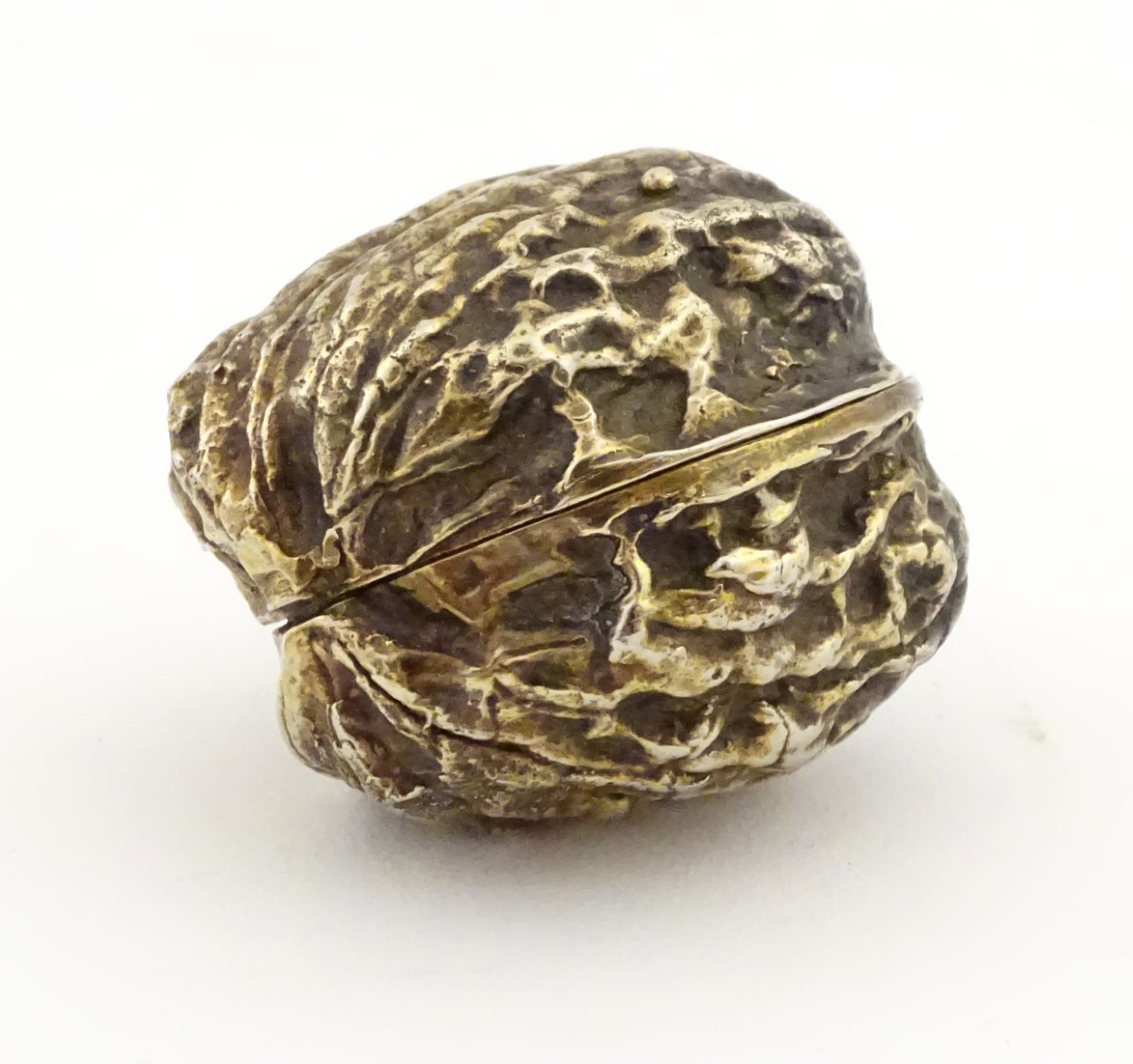 A 21stC gilded white metal novelty small box formed as a walnut.