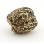 A 21stC gilded white metal novelty small box formed as a walnut.