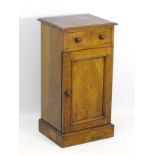 A late 19thC walnut bedside cabinet with moulded top edge above single short drawer with turned