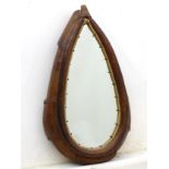 A 20thC leather collar saddle mirror of tear drop form, with woven detailing surrounding the mirror.