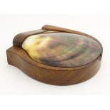 A mahogany trinket box with a large polished mother-of-pearl, scallop-shaped shell lid.