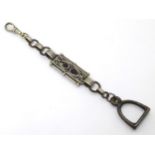 A silver plate watch chain with scroll and stirrup decoration.