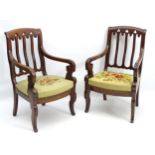 A pair of French 19thC mahogany library chairs in the Gothic manner,