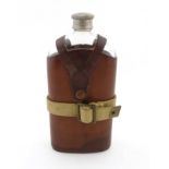 Militaria: A large WWI-era pigskin covered hip flask with pewter top and British army webbing strap,