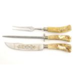 A Solingen carving set with antler handles with stylised stag decoration,