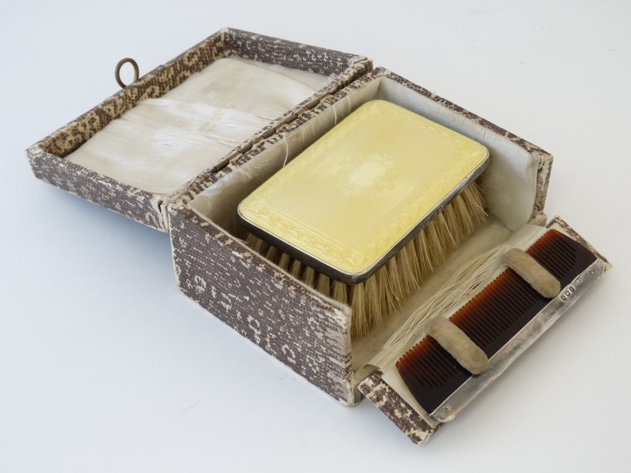 A silver backed hairbrush of rectangular form with yellow guilloché enamel decoration hallmarked