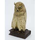 A large novelty cold painted bronze model of an owl perched upon a book,