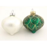 Christmas decorations : two glass baubles one green the other white.