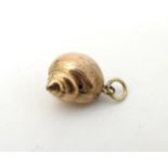A gilt metal pendant formed as a shell.