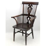 An early 19thC WIndsor chair constructed from fruitwood with an elm seat,