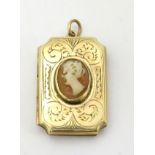 A gold plated locket pendant set with central cameo decoration. The whole 1” high.