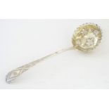 A 19thC silver ladle with engraved decoration and fruiting vine decoration with gilded bowl.