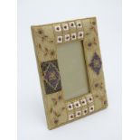A 21st C Photograph frame with beadwork and silk surround having Mother of Pearl additions.