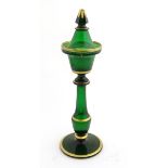 A Victorian tea light holder with a conical snuffer of green glass with gilded decoration, approx.