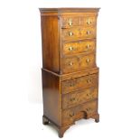 An early 20thC walnut chest on chest with moulded cornice above chanted fluted corners,