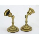 An unusual pair of brass candlesticks, having adjustable/angled sconces, marked 'The New London T.R.