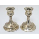 A pair of silver candlesticks hallmarked Birmingham 1922 maker Sydney & Co.