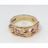 A 9ct gold ring with rose gold Art Nouveau like decoration and stamped with Welsh? dragon.